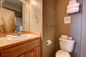 a bathroom with a toilet and a sink and a mirror at River Pines Inn in Winthrop +38 photos