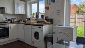 a kitchen with a washer and dryer at NG Property in Glasgow