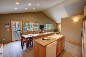 a large kitchen with a table and a sink at River Pines Inn in Winthrop