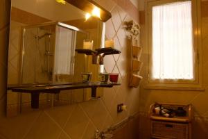 a bathroom with a mirror and a sink at Casa Arcobaleno in Marsala +21 photos