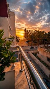 a view of a sunset from the balcony of a building at AL MIDYAF Appart'Hôtel in El Jadida