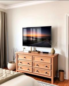 a bedroom with a television on top of a dresser at Luxury Room In McDonough in McDonough