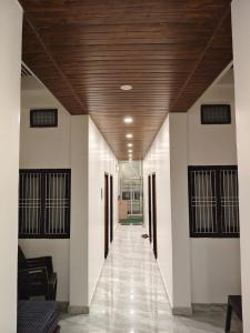 a hallway in a building with a wooden ceiling at Hotel Ram Shankar - Saryu Ghat in Ayodhya