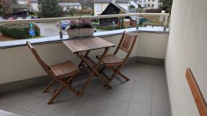 a table and two chairs on a balcony at Apartmán Velké Losiny in Velké Losiny