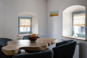 a dining room with a wooden table and chairs at Lukova hiša- Luka's house in Vipava