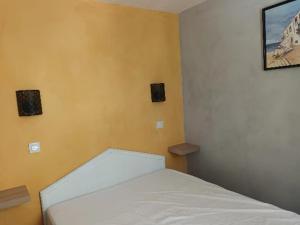 a bedroom with a white bed in a room at le dramont in Saint-Raphaël