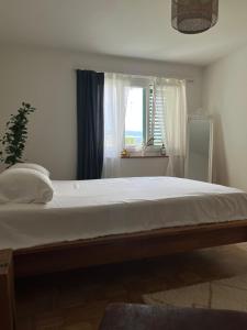 a bedroom with a large bed with a window at Apartment in Stäfa in Stäfa