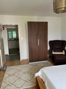 a bedroom with a bed and a closet and a chair at Apartment in Stäfa in Stäfa +4 photos