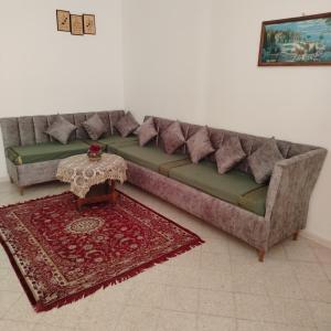a couch in a living room with a rug at Location Kelibia in Kelibia