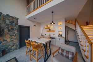a kitchen and dining room with a table and chairs at Nish Vadi Villas in Sapanca