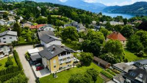 an aerial view of a town with a large yellow house at Feistritzer in Seeboden +23 photos