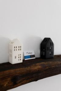 two toy buildings sitting on a wooden shelf at Lukova hiša- Luka's house in Vipava +29 photos