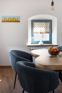a kitchen with a table with chairs and a bowl of fruit at Lukova hiša- Luka's house in Vipava