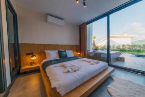 a bedroom with a large bed with towels on it at Nish Vadi Villas in Sapanca +146 photos