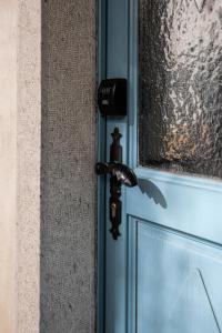 a black door handle on a door with a window at Lukova hiša- Luka's house in Vipava