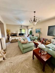 a large living room with couches and a table at Villa w Studio, Pool, Garden, Sleeps 12 to 15 in Rákhai