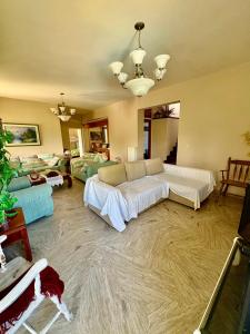 a living room with two beds and a couch at Villa w Studio, Pool, Garden, Sleeps 12 to 15 in Rákhai +23 photos