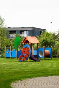 a playground in a park with a slide at Naglio apartamentai Elija in Šventoji