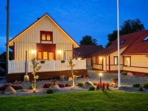 a house with lights in the front yard at Kalvi tee Puhkemaja in Viru-Nigula
