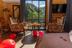 a room with a bed and chairs and a table with red balloons at Pallas Suit in Ardeşen