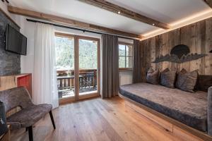 a bedroom with a large bed and a window at Oberkantiolhof in Villnoss