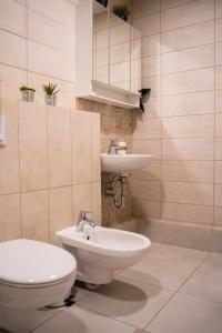 a bathroom with a toilet and a sink at Naglio apartamentai Elija in Šventoji +33 photos