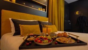 a tray of food on top of a bed at L'Écrin d'Or - Spa - Cinéma privé in Saumur