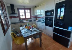 a kitchen with a table with a bowl of fruit on it at Ilodays in La Plaine des Cafres