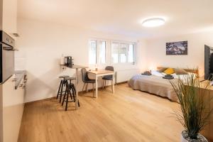 a bedroom with a bed and a desk and a table at Studio Omis in Zermatt