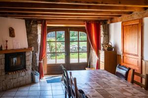 a dining room with a table and a large window at gite les ducs in Mialanes
