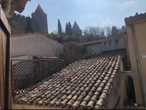 a tile roof of a building with a fence at Chez-YU au pied de la cité in Carcassonne