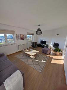 a living room with a couch and a table at Casa da Mata in Paredes de Coura