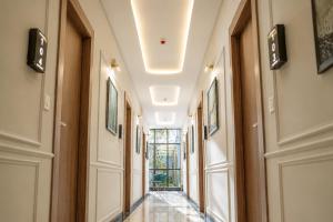 a hallway of a building with doors and a window at The Park Central in Lucknow