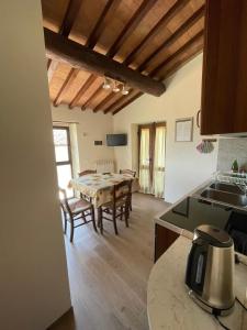 a kitchen and a dining room with a table at Agriturismo Podere La Casaccia in Poppi