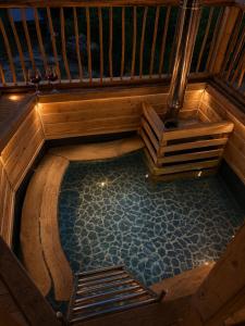 an overhead view of a swimming pool in a wooden house at Cabana cu trofee in Schitu-Tarcău