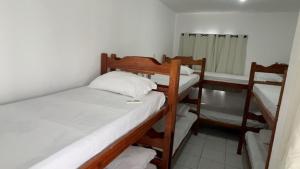 a room with two bunk beds and a radiator at Encantos do Mar Hostel in Recife