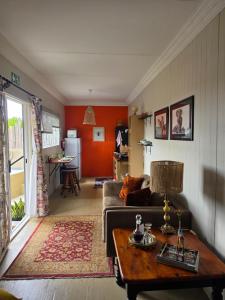 a living room with a couch and a table at Motubane Guest Farm in Madeteleli