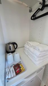 a shelf in a kitchen with towels and a tea pot at Soleil Bleu in Vila Nova de Milfontes +36 photos