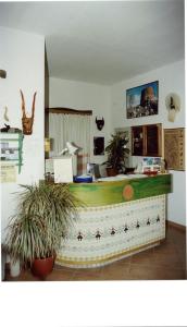an office with a desk with plants in a room at Sant Efisio in Lotzorai