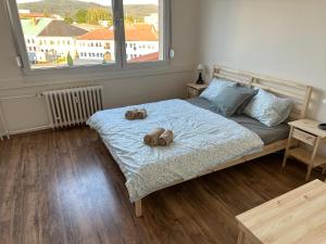 a bedroom with a bed with two stuffed animals on it at Apartmán Volary in Volary