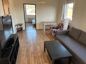 a living room with a couch and a table at Apartmán Volary in Volary