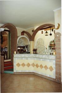 a bar in a restaurant with arches at Sant Efisio in Lotzorai