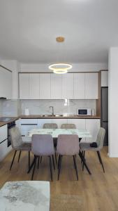 a kitchen with a table and chairs in a kitchen at Golden Space Apartment 3 in Tirana