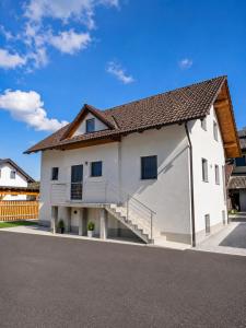 a white house with a staircase on the side of it at The River House in Mavčiče