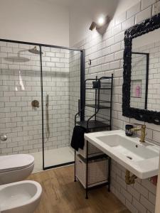 a bathroom with a sink and a toilet and a shower at Affittacamere Le Canossiane in Piedimonte dʼAlife +30 photos