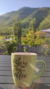 a coffee cup with writing on it sitting on a table at Jovanov Residence - the Landscape Beauty in Dolna Matka