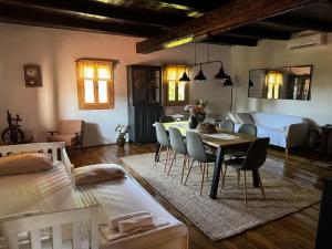 a living room with a table and chairs and a bedroom at Čardak Mraclin in Mraclin