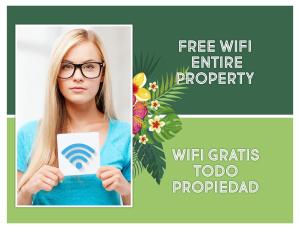 a woman with glasses holding a card with a wifi antenna property at FIESTA LOS CORALES - VILLAS and SUITES in Punta Cana +35 photos