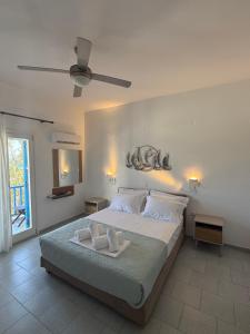 a bedroom with a bed with two towels on it at Studios Panorama Drios in Drios +182 photos