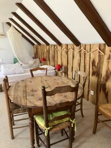 a dining room with a wooden table and chairs at Gîte Béthel in Lachamp-Raphaël
